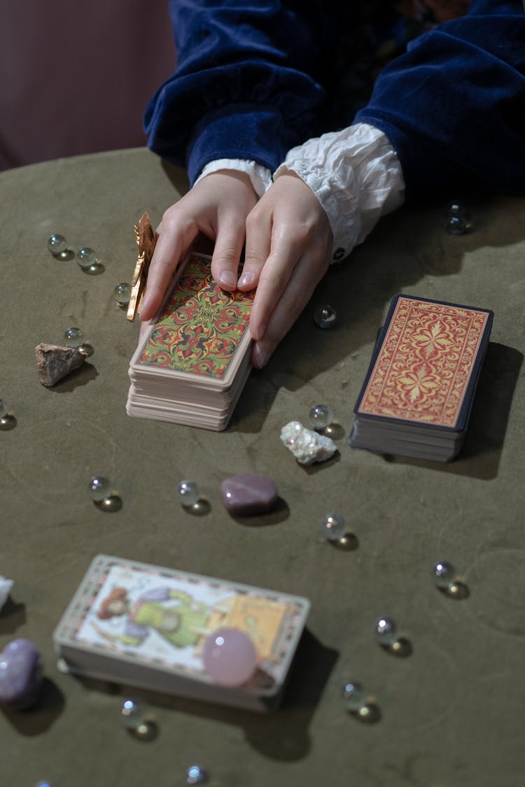 Person Holding A Deck Of Cards