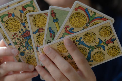 Close-Up Shot of a Person Holding Tarot Cards