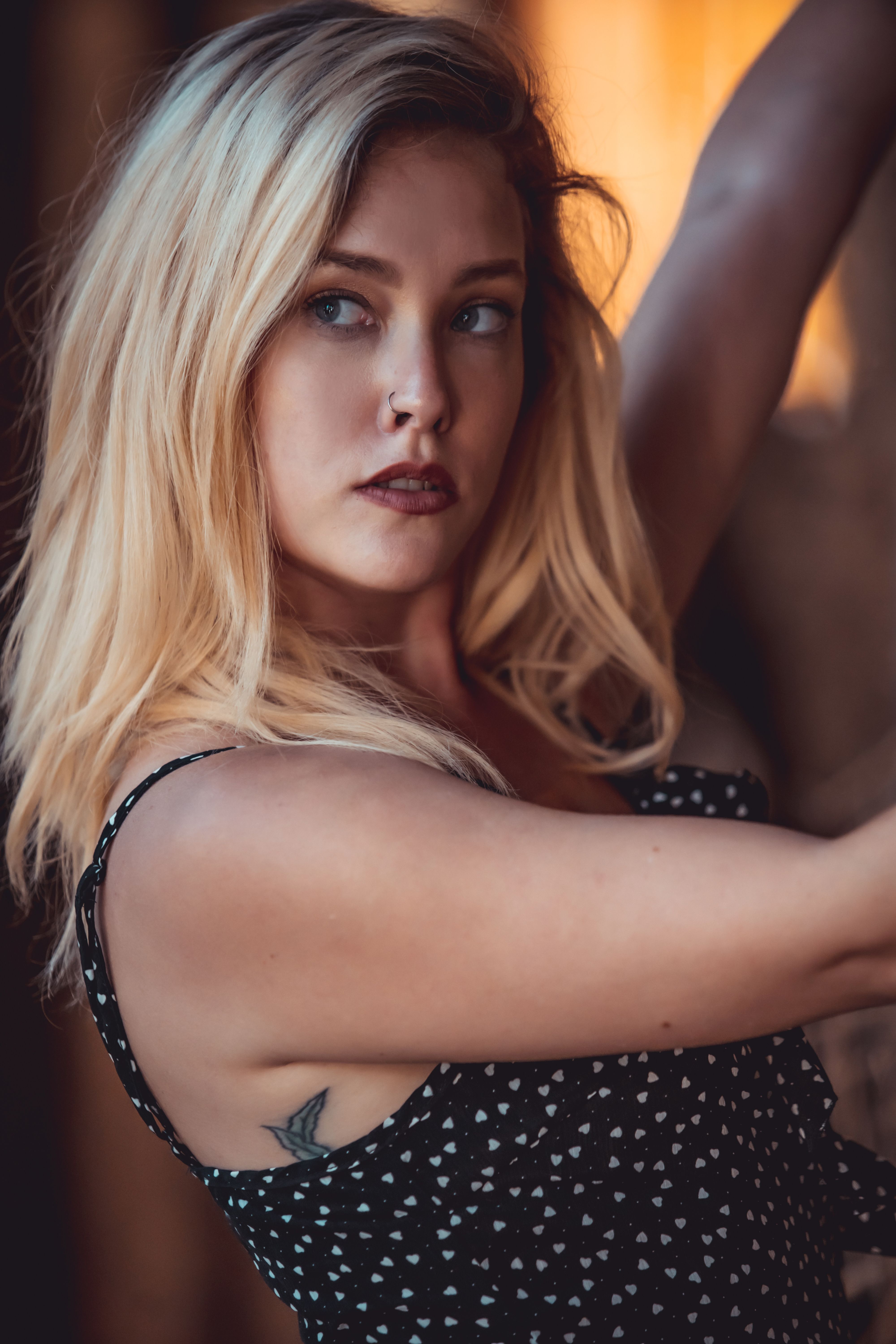 Close-up portrait of a blonde woman posing gracefully in natural light, showcasing beauty and elegance.