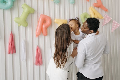Free Mother Giving a Kiss to Her Daughter Stock Photo