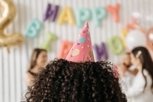 Vibrant birthday party scene featuring a person wearing a festive party hat.