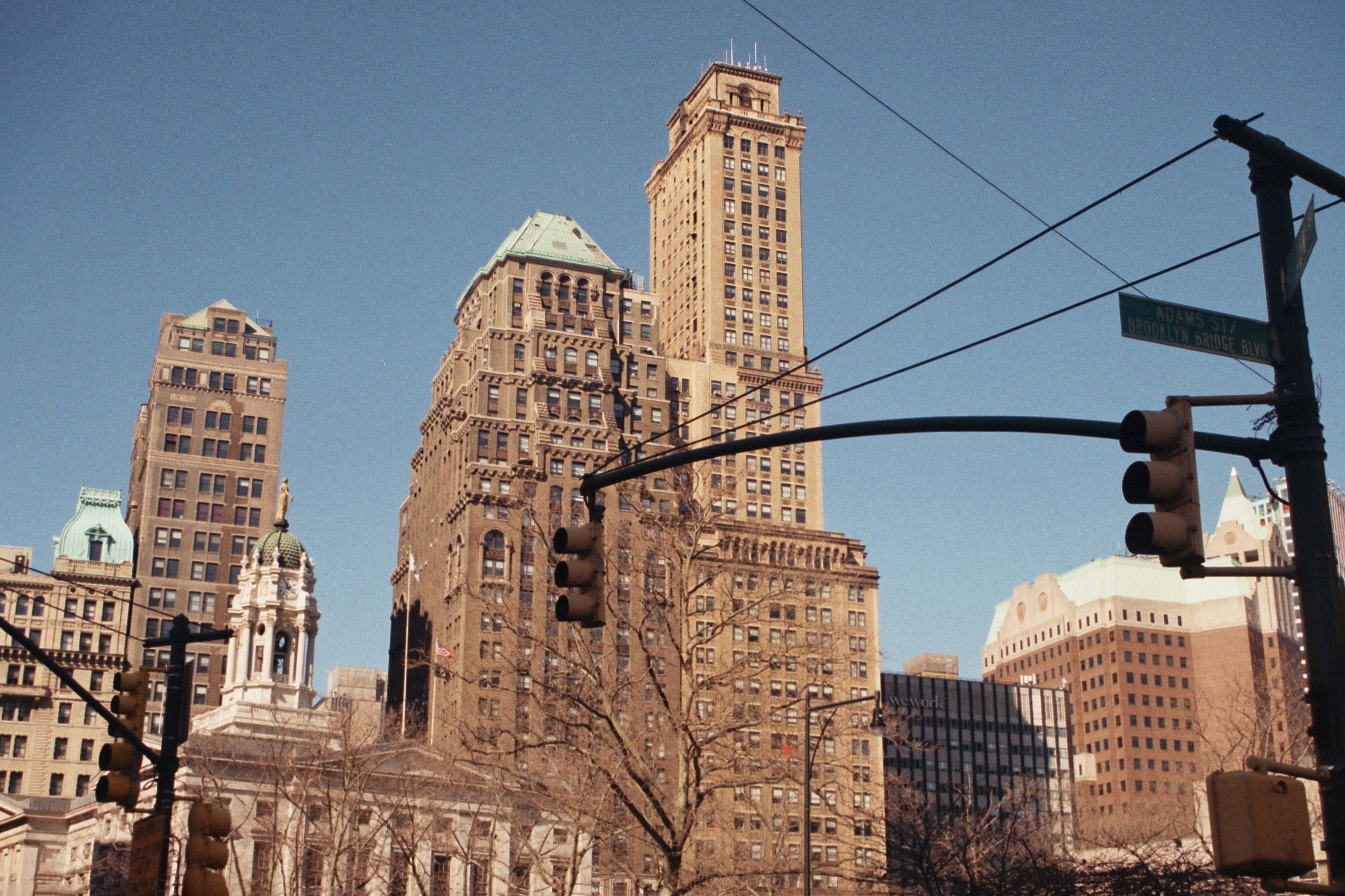 View of Brooklyn's historic skyscrapers and iconic traffic lights under a clear sky.