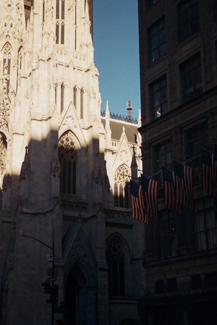 Gothic Cathedral Beside Building With American Flags