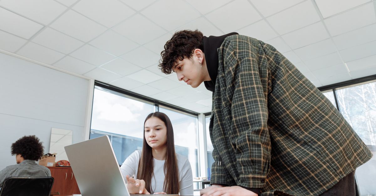 Man and Woman Using a Laptop Computer · Free Stock Photo