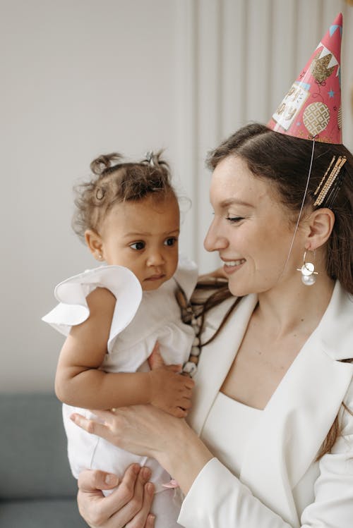 Free Woman Carrying Her Daughter Stock Photo