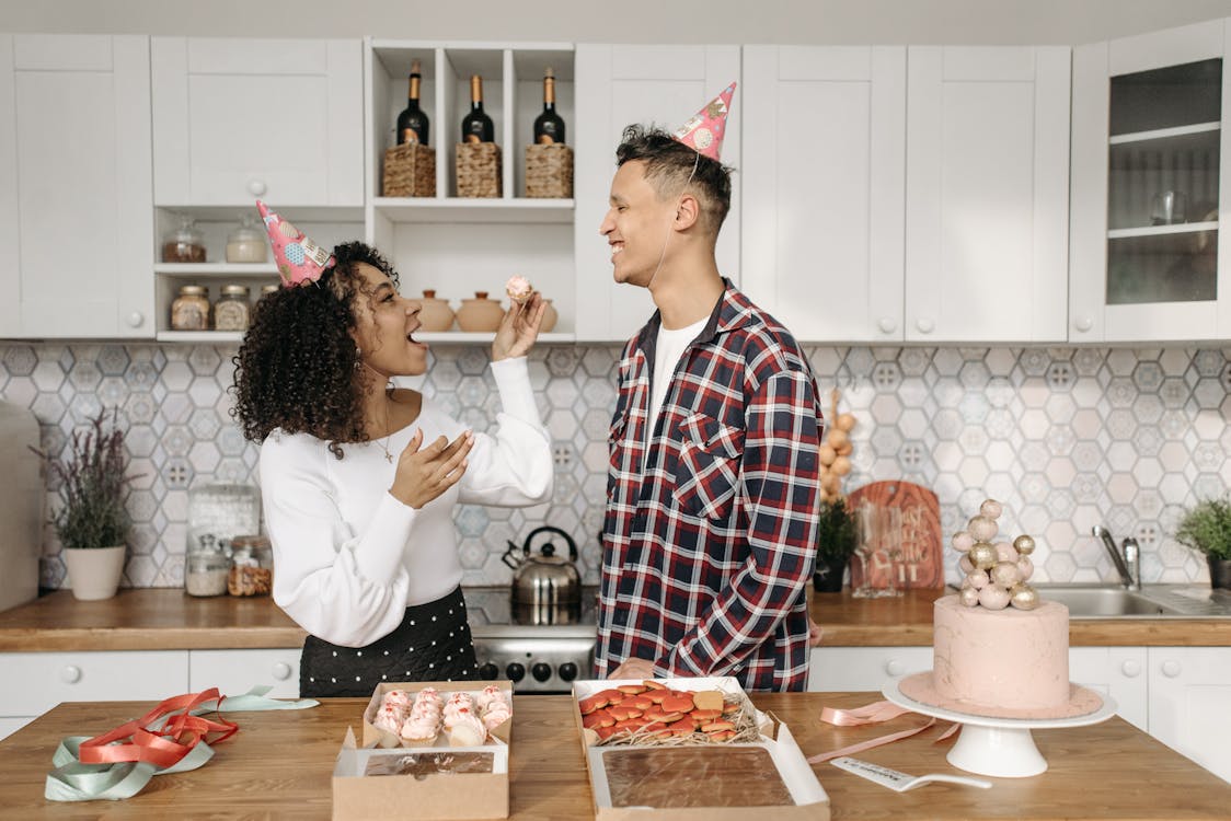 Free Woman in White Long Sleeve and Man in Checkered Long Sleeve Eating Dessert Stock Photo