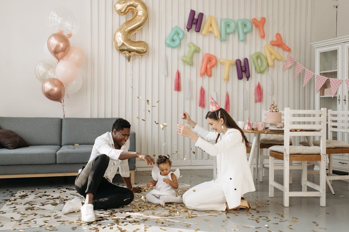 Mom and Dad Celebrating with their Child's Birthday at Home