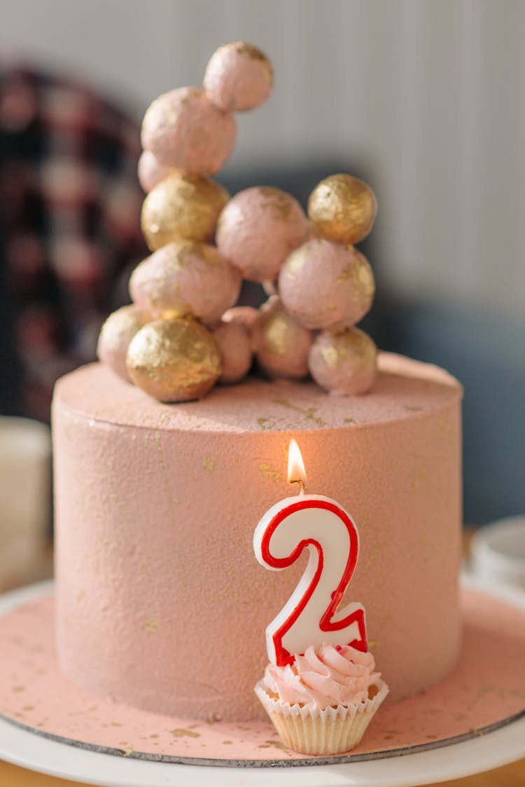 Birthday Cake On A Table With Number On A Cupcake