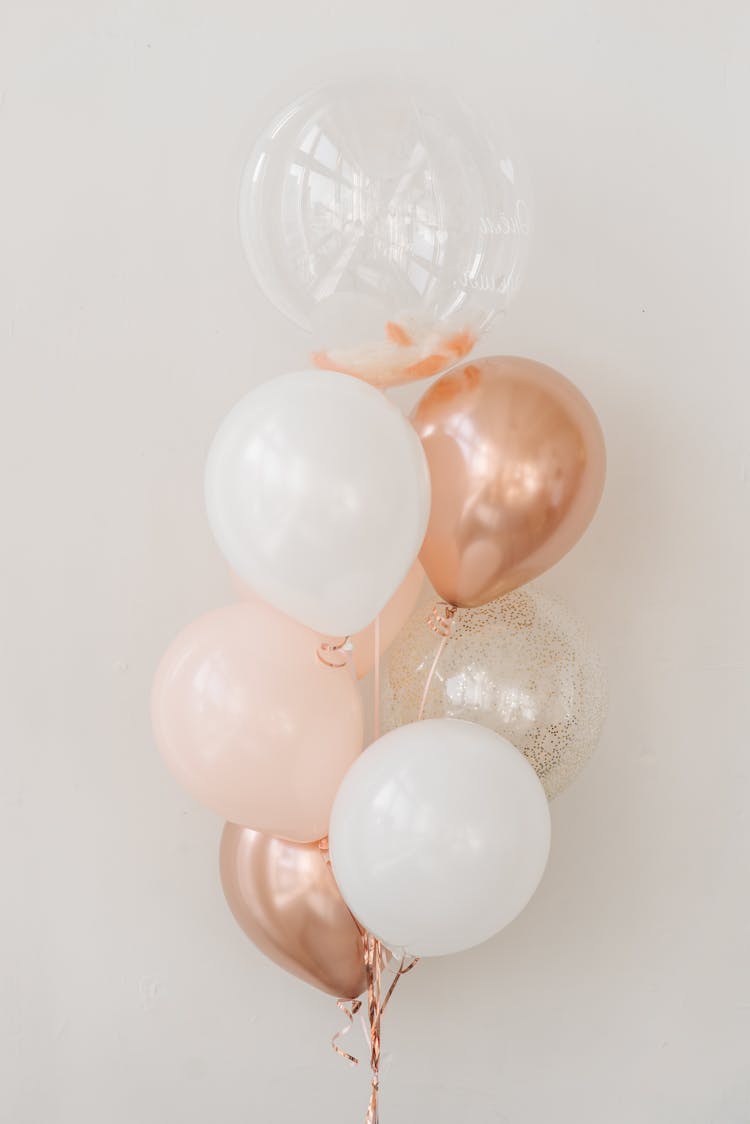 Metallic, White And Transparent Balloons Beside White Wall