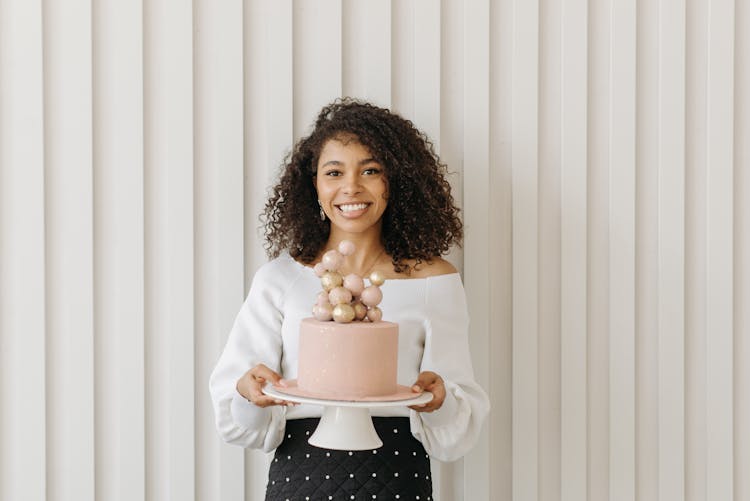 Woman In White Long Sleeve Shirt Holding A Birthday Cake