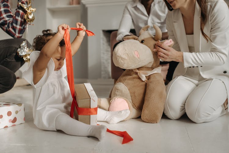 Child Unwrapping Her Birthday Presents