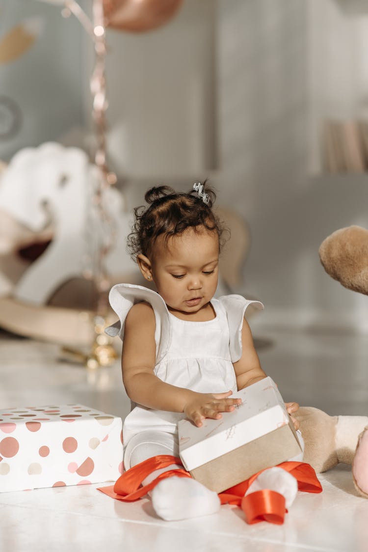 Child Unwrapping Boxes Of Birthday Present