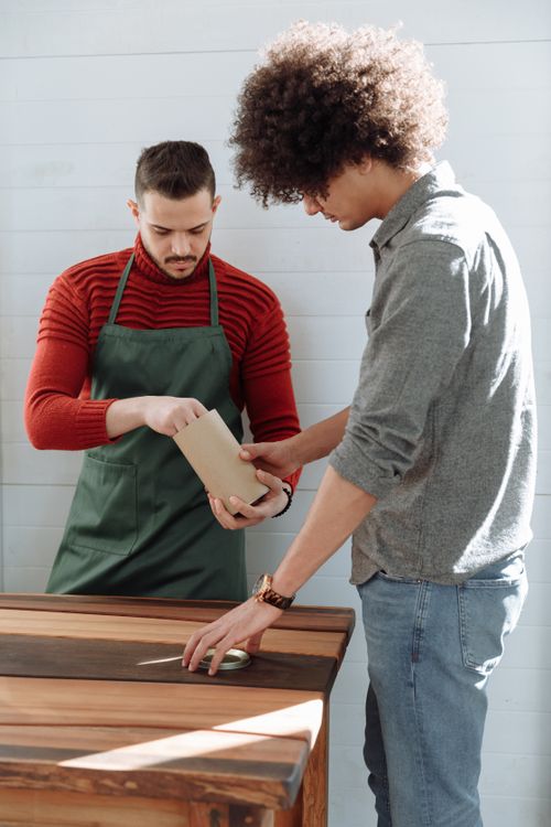 Free Two men working together on a woodworking project indoors. Stock Photo