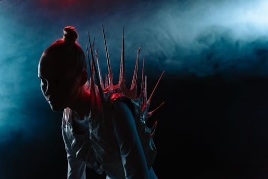 A dramatic silhouette of a woman in a spiky costume with a sci-fi aesthetic and smoke effect.