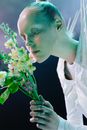 Woman in White Wedding Dress Holding White Flower Bouquet