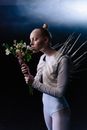 Woman in White Long Sleeve Shirt Holding White Flowers