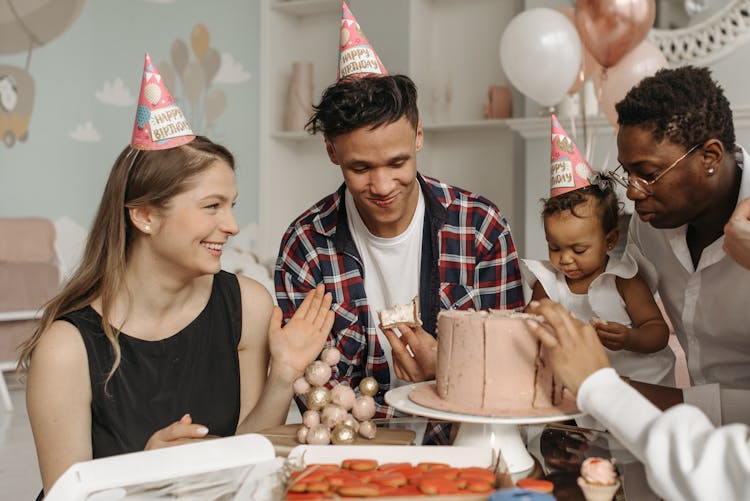 People Eating Baby Girl's Birthday Cake