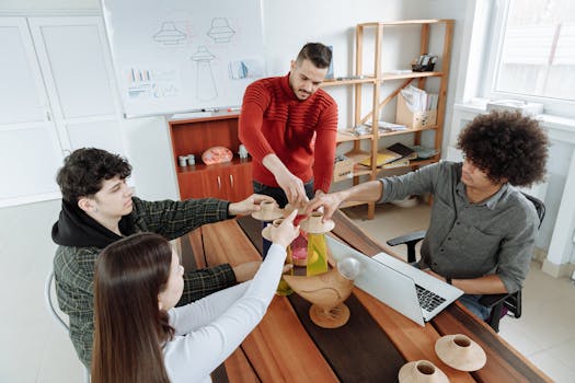 Diverse team collaborating on a creative project around a wooden table in a modern office.