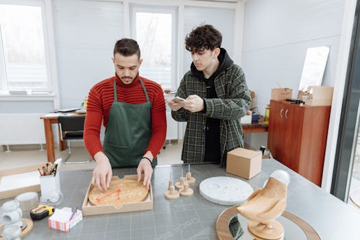 Two men in a creative workspace assembling clocks, capturing industrial and craft elements.
