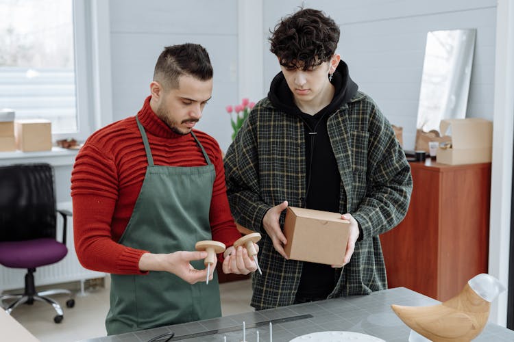 Men Looking At A Product And It's Packaging