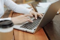 Woman Typing on Laptop
