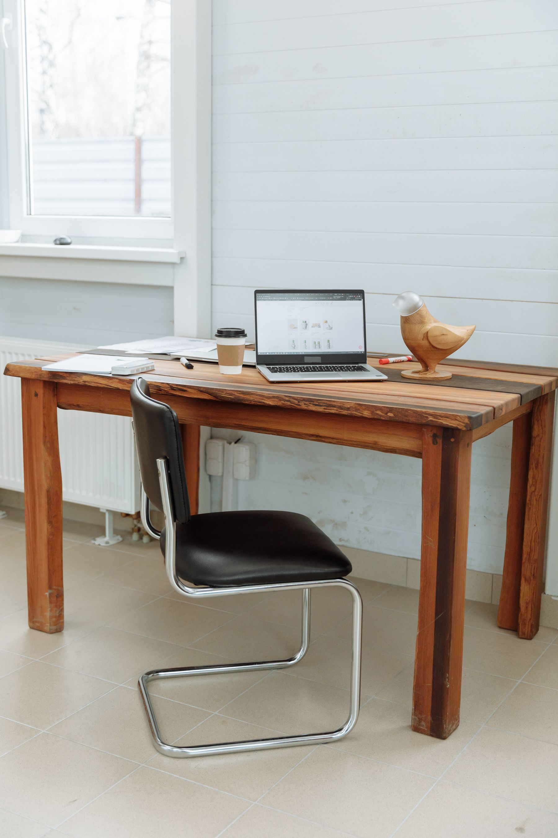 Designer workspace with a website displayed on a computer in a bright studio