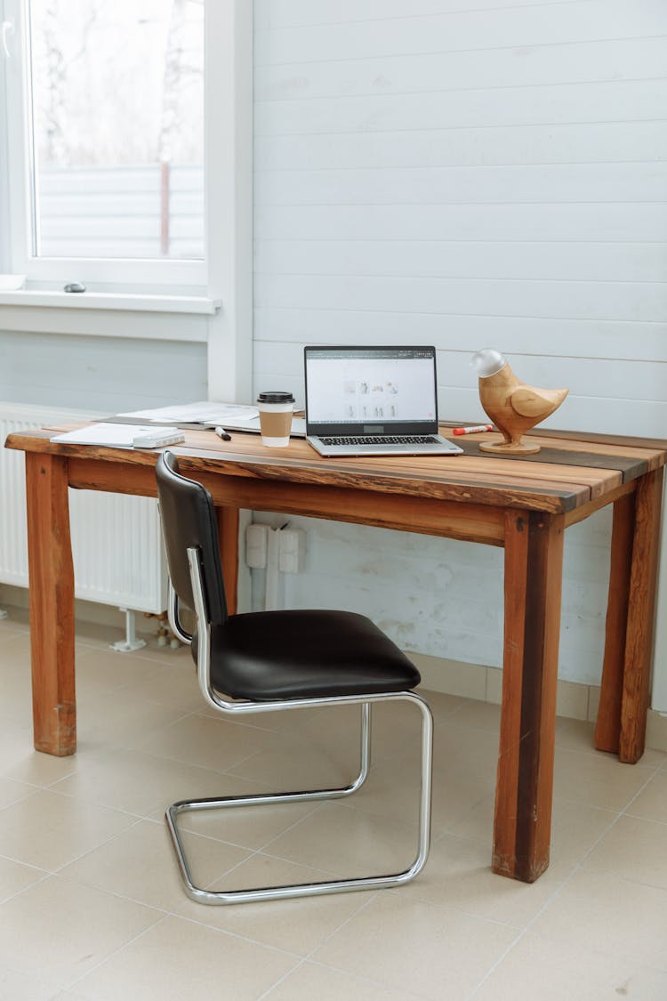 Computer On A Wooden Desk With The Designer's Business Website On The Screen