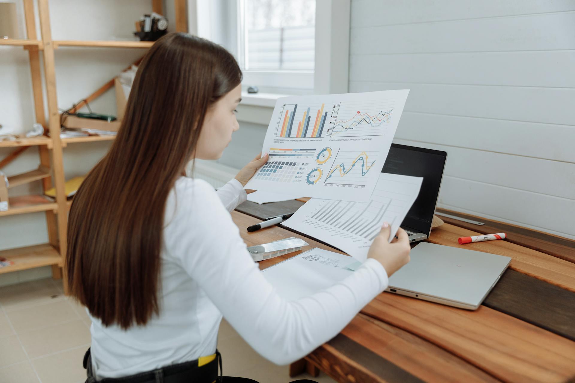 Woman Analyzing the Design Business Progress Reports