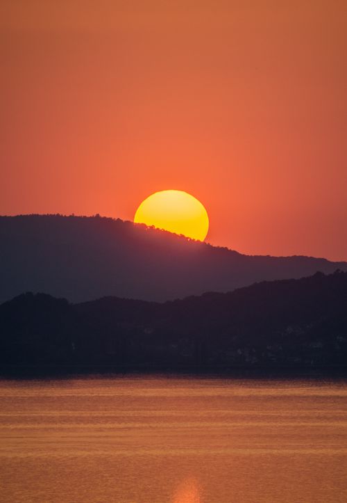 Free Stunning sunset over Lake Balaton hills, capturing the serene beauty of Fonyód, Hungary. Stock Photo