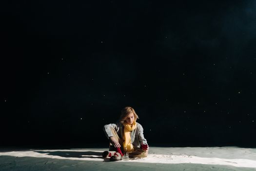 A young person cosplaying as the Little Prince under a starry night sky holding a rose.