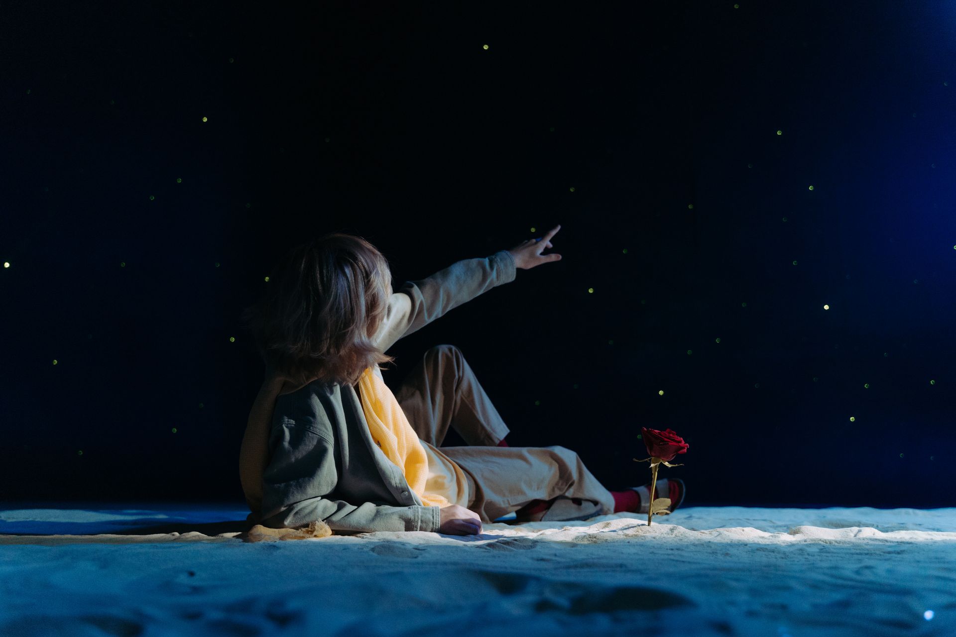 A Boy Lying on the Sand while Looking at the Stars