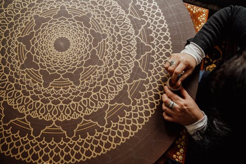 Person Holding Brown Round Rug