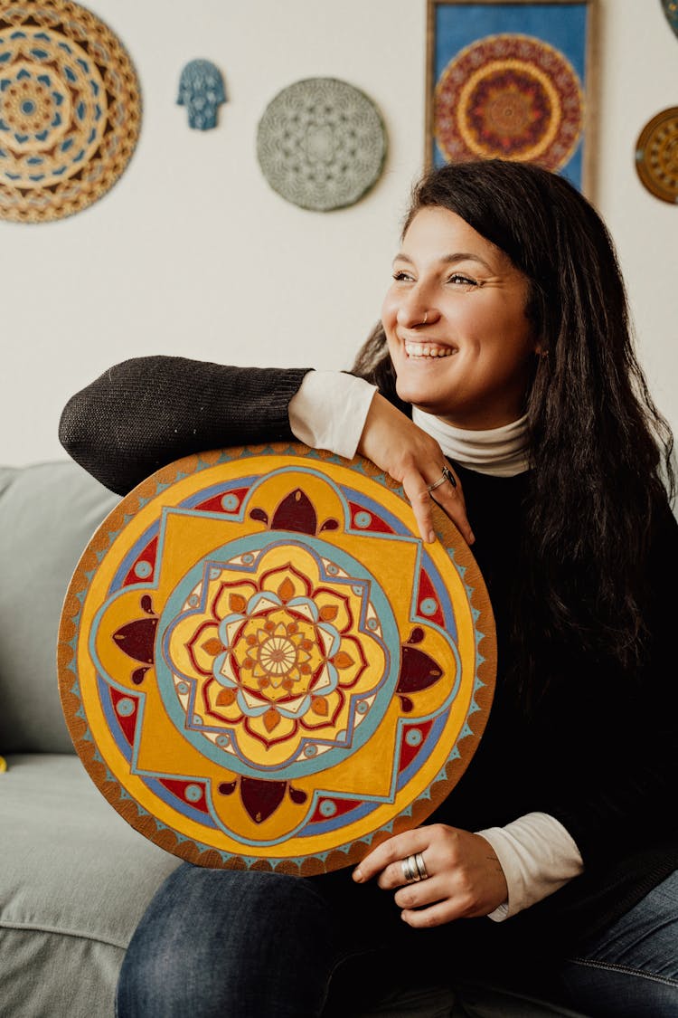 Smiling Woman Holding Mandala Painting