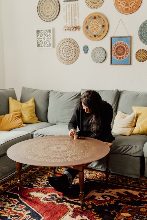 A Man Sitting on the Couch while Painting