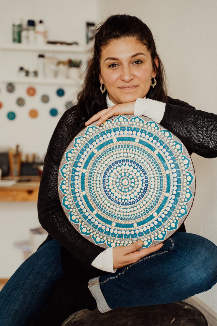 A Woman Holding Blue Painting