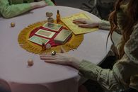 Person Holding Gold and Red Round Ornament