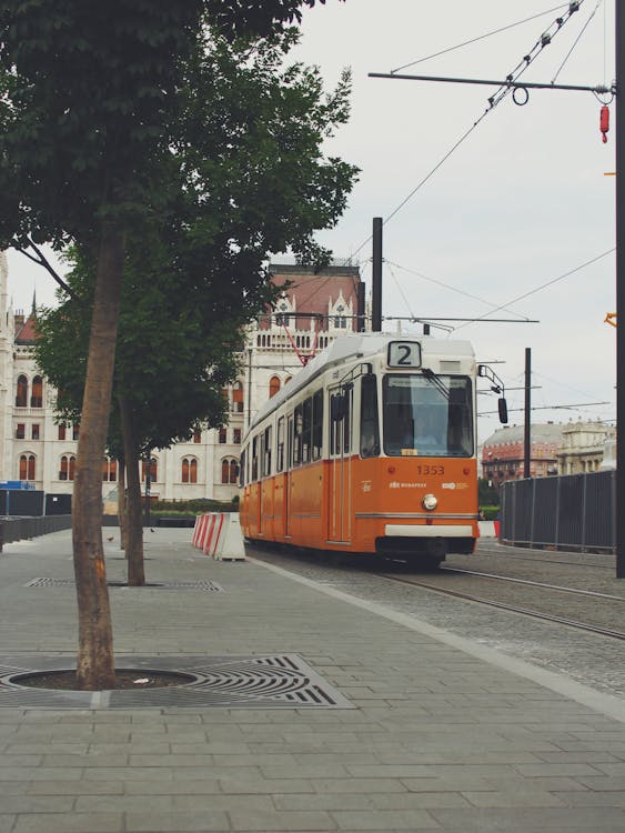 Orange and White Tram on the Road