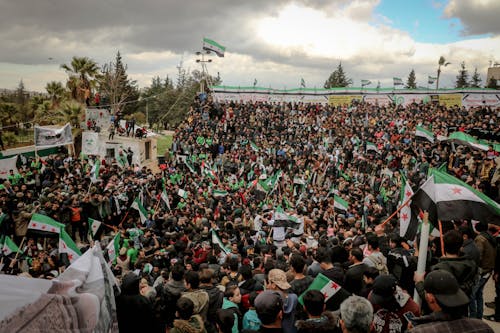 A Gathering of People Holding Flags