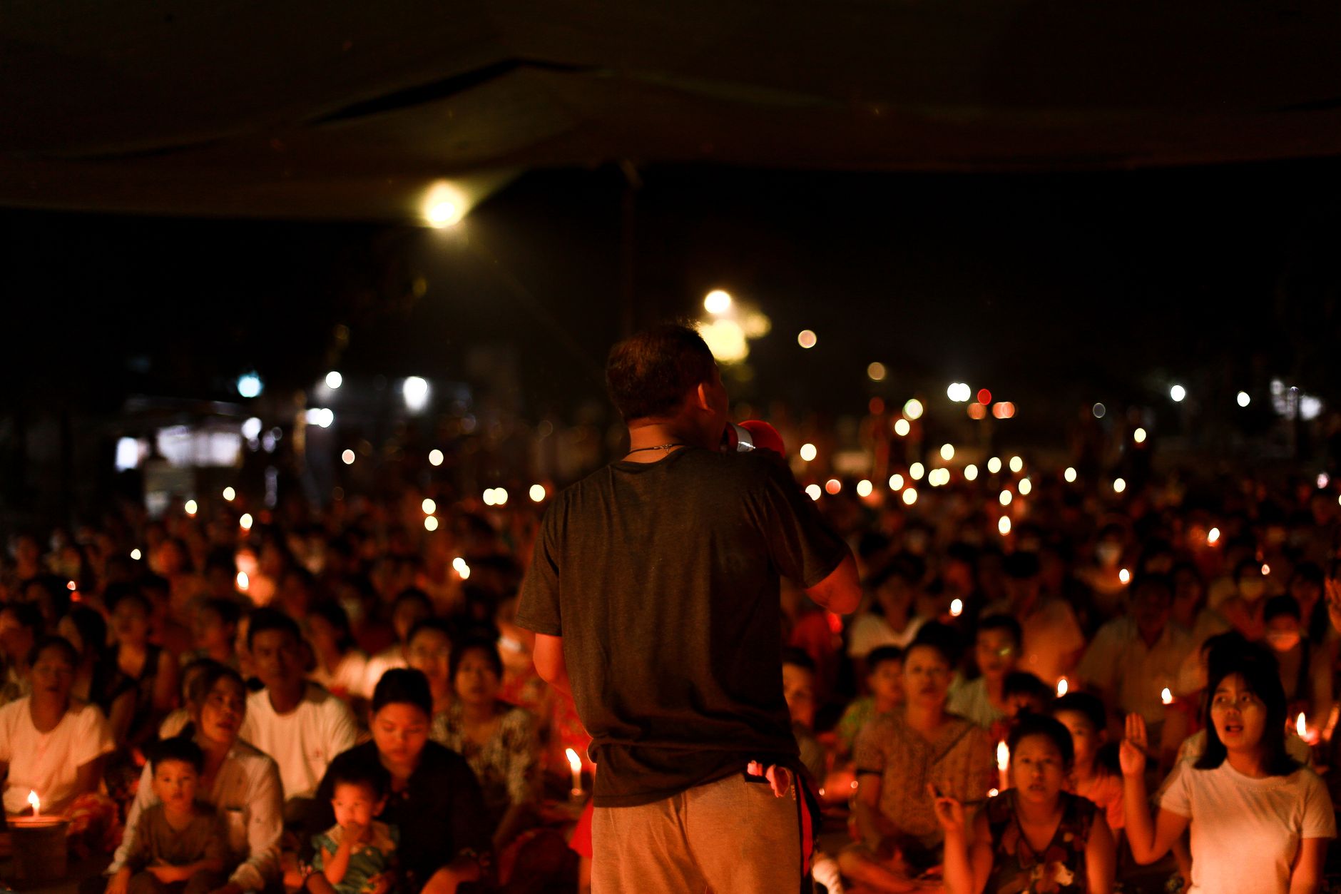 A peaceful candlelight vigil at night in Yangon, capturing a sense of community.