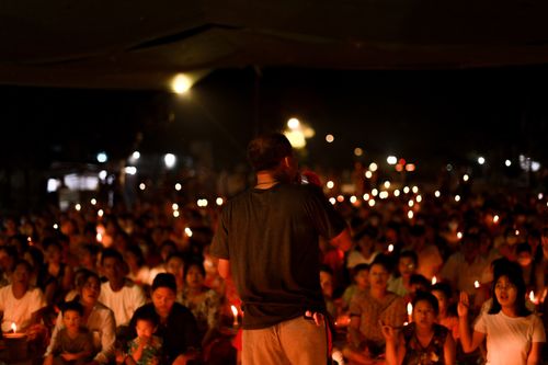 Free A peaceful candlelight vigil at night in Yangon, capturing a sense of community. Stock Photo