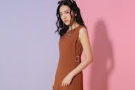 Woman in fashionable brown outfit in studio