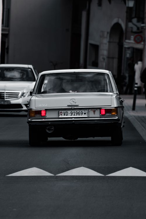 Free Vintage Mercedes Benz car driving on urban street in Germany, showcasing retro charm and elegance. Stock Photo