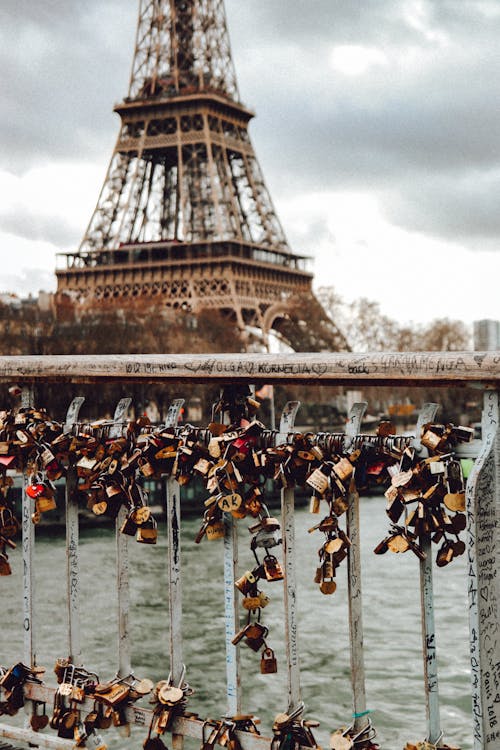 Free Padlocks at the Love Locks Bridge with the Eiffel Tower on the Background in Paris Stock Photo