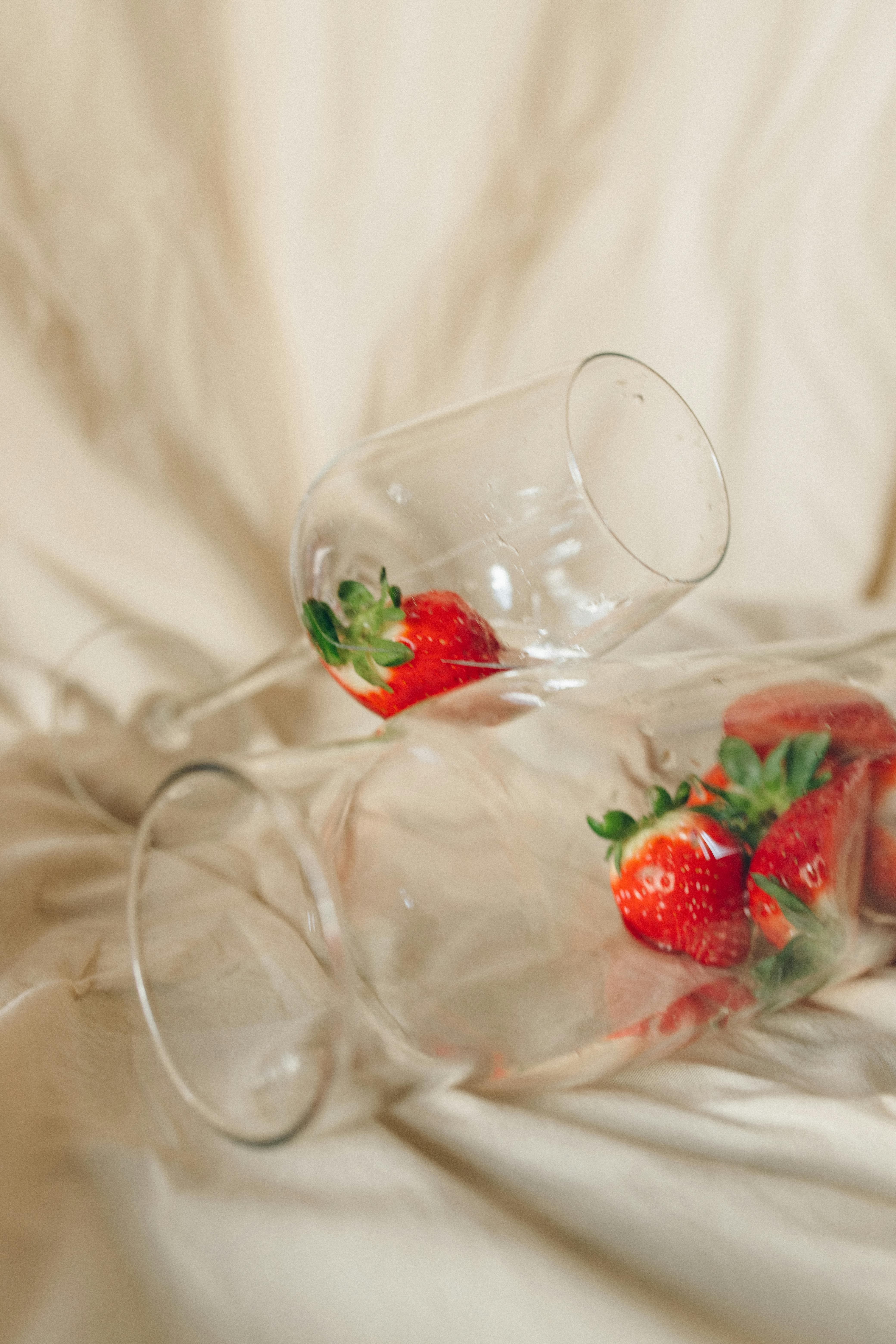 red strawberries in clear glass bowl