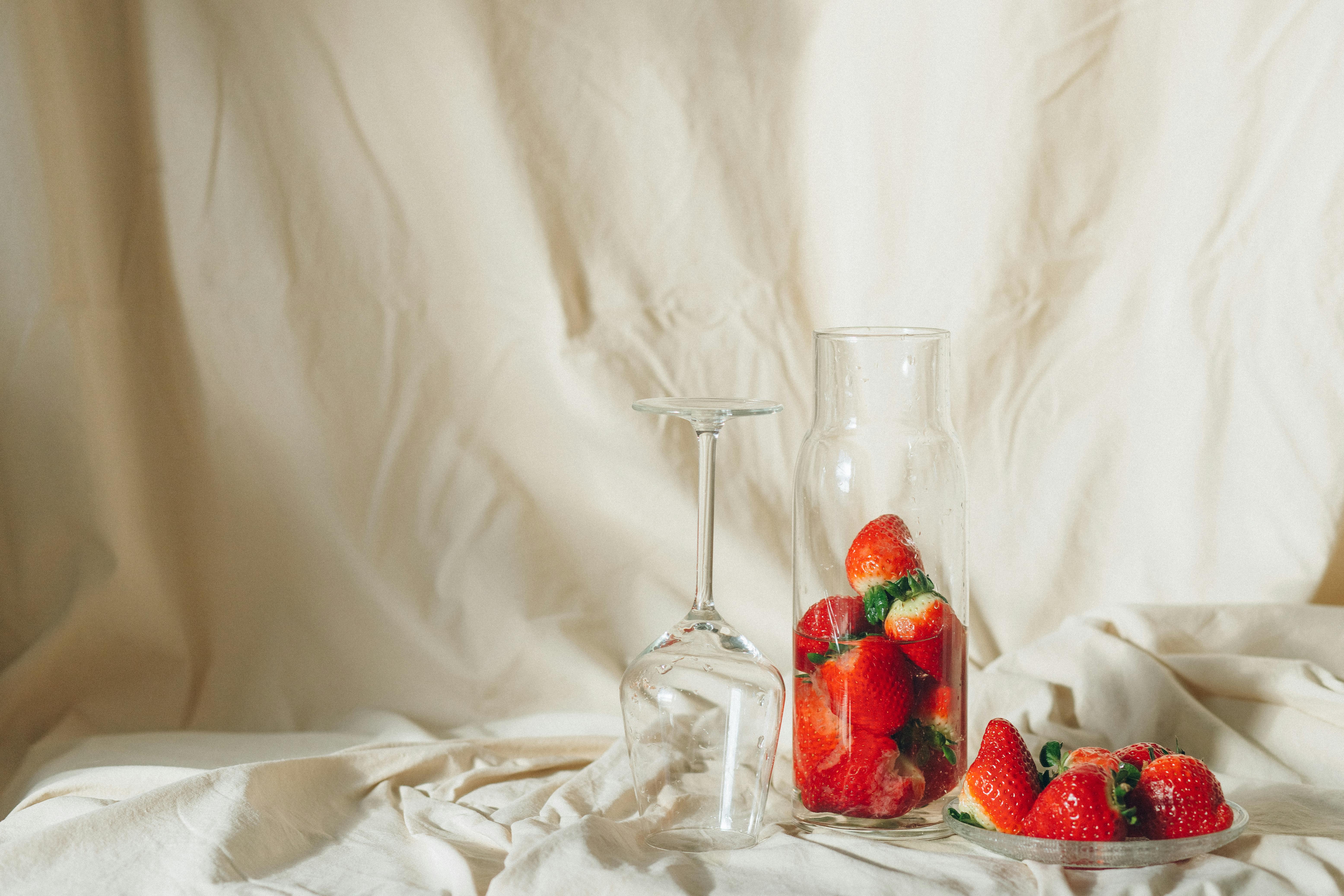 strawberries in clear glass bowl