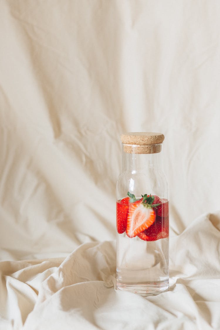 Sliced Strawberries In A Clear Glass Jar