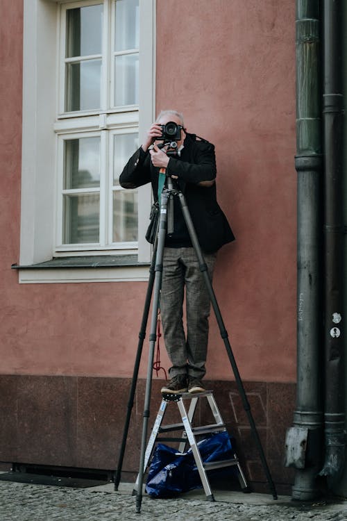 Photographer Using a Camera on a Tripod
