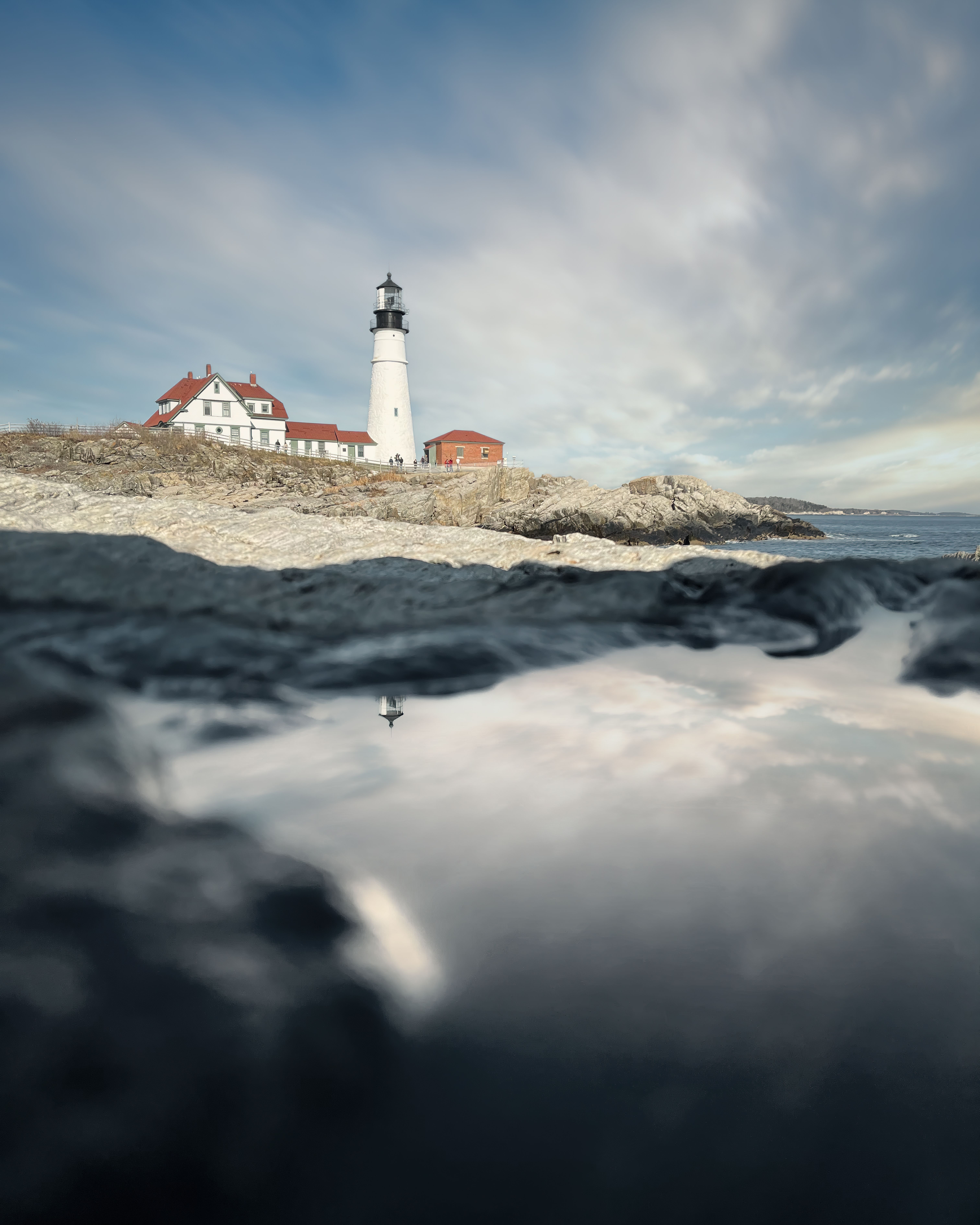 White and Black Lighthouse Near Gray Body of Water · Free Stock Photo
