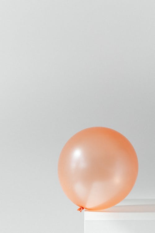Free Orange Balloon on White Surface Stock Photo