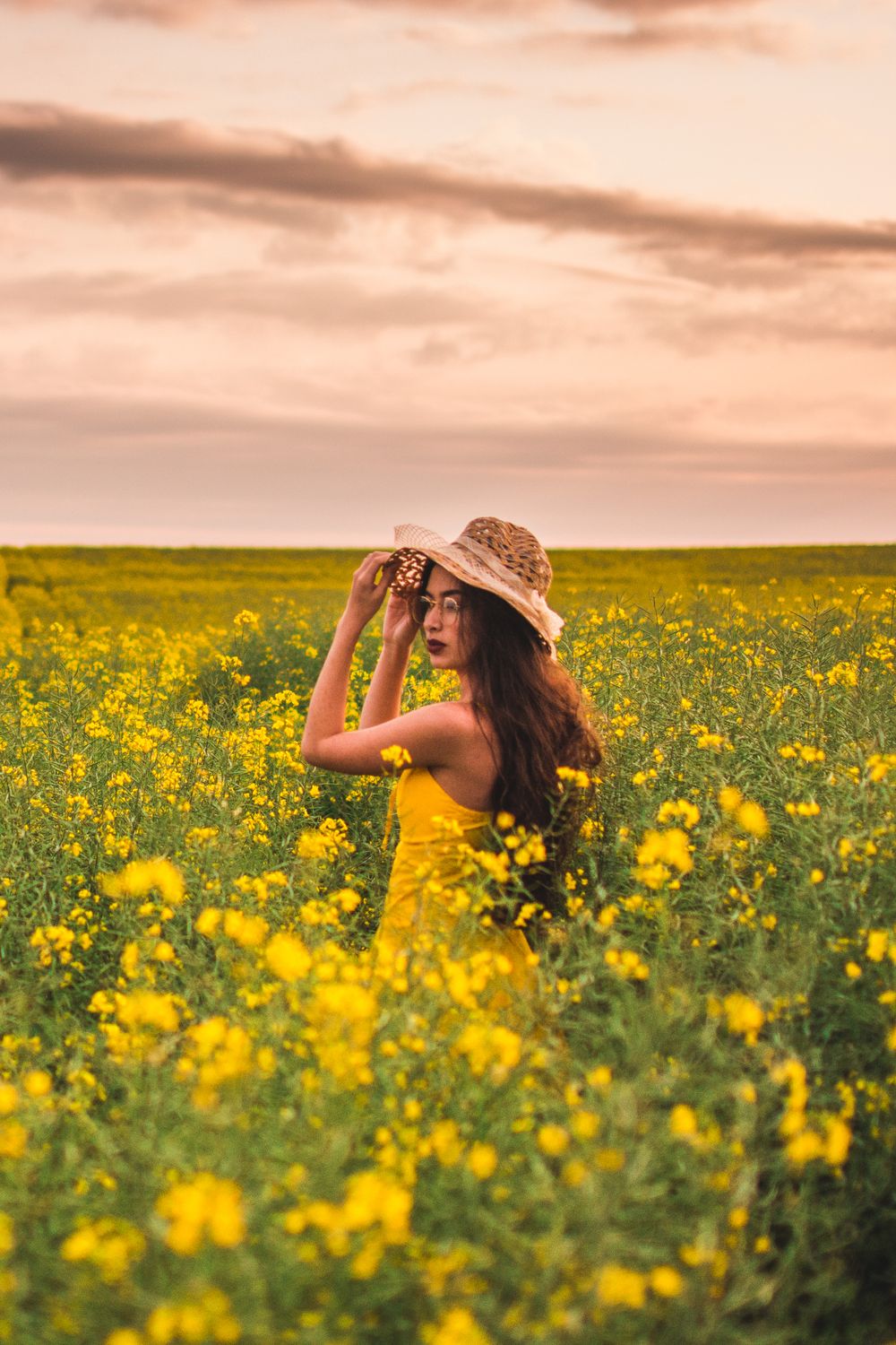A Woman in Yellow Dress Standing in the Middle of Yellow Flower Field ...